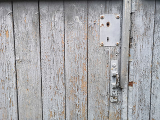 texture of an old fence from boards with peeling gray paint. background old painted board