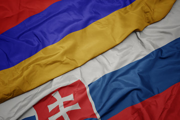 waving colorful flag of slovakia and national flag of armenia.