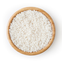 Uncooked round rice in wooden bowl isolated on white background with clipping path