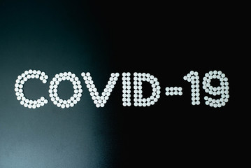 Covid-19 - Wuhan Novel Coronavirus made by many medicine pills isolated on black