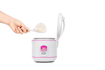Women hand holding ladle  scooping cooked rice From  electric rice cooker isolated on white...