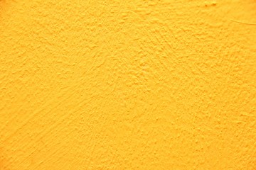 Naklejka premium Yellow wall texture. Bright warm yellow wall background