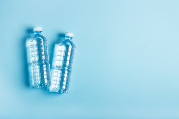 water bottles on a blue background. Health concept