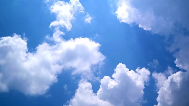 White clouds moving over blue sky, Time lapse of white fluffy cloud across blue sky background 4k