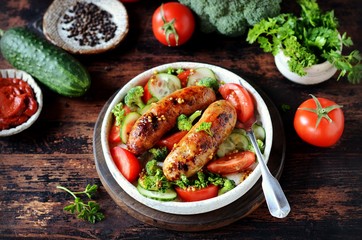 Homemade chicken (turkey) fried sausages with broccoli, tomato and cucumber salad 