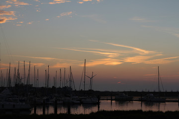 evening falls over the marina with still light spots in the air