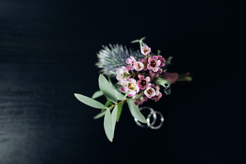 Beautiful boutonniere made of pink flowers for the groom
