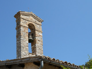 bell tower of an old church against a blue sky as background