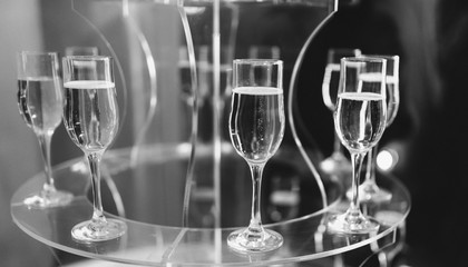 Elegant glasses with champagne standing in a row on serving table