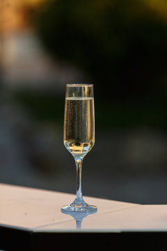 Close-up image of champagne in a glass with blurry light background