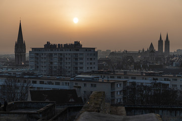 Fototapeta premium Gorgeous cityscape from the castle of Caen with a thick haze over the city