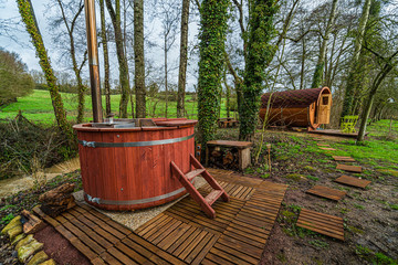 Hot and relaxing wooden bath in green and peaceful French countryside