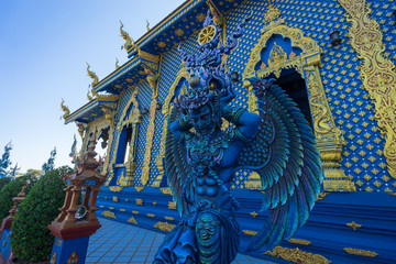 Fototapeta na wymiar Chiang Rai, Thailand - December 23, 2019: Beautiful angel-like being guards sculpture at Wat Rong Suea Ten, The Blue temple in Chiang Rai, Thailand.