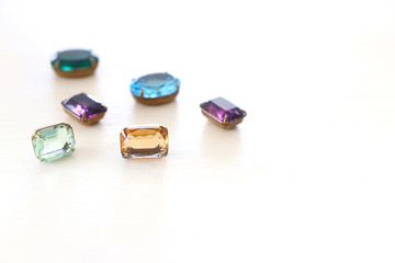 Beautiful crystal clear jems over white wooden background