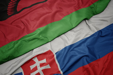 waving colorful flag of slovakia and national flag of malawi.