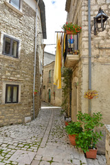 Fototapeta na wymiar A narrow street between the old houses of the medieval village of Oratino, in Italy.