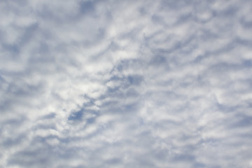 Grey abstract clouds lines on blue sky background