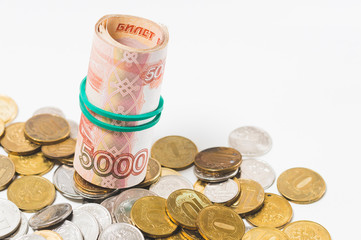 five thousand rubles in banknotes and coins, on a white background, the concept of money savings in...