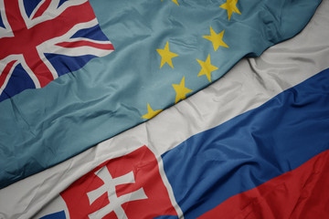 Fototapeta premium waving colorful flag of slovakia and national flag of Tuvalu .