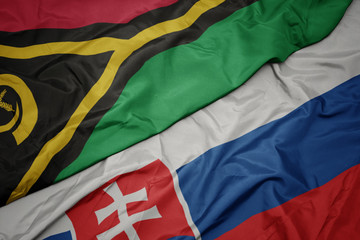 waving colorful flag of slovakia and national flag of Vanuatu .