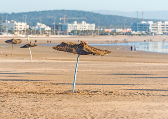 Parasol on the sandy beach, Essaouira, Morocco.
