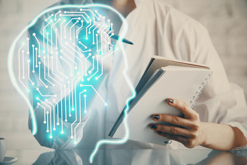 Multi exposure of writing hand on background with brain hologram. Concept of self learning.