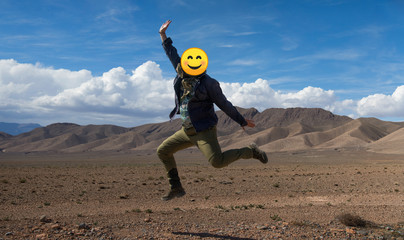 Man jumping for joy with mountains in the background
