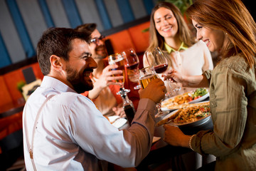 Young people having dinner in the restaurant