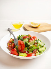 Salad of tomatoes, cucumbers and herbs. Healthy food, vegan, vegetarian.