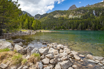 Beautiful Pyrenees mountain landscape, nice lake with transparent water from Spain, Catalonia.