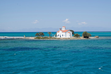 Fototapeta na wymiar Small white traditional church close to Elafonisos Port in Greece