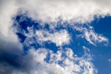 Bright white clouds on blue sky. Spring sunny day. Beautiful nature background.