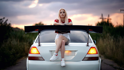 Girl sitting on a car