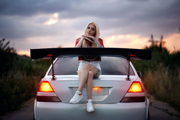 Girl sitting on a car