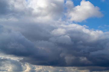 Grey white clouds. Thunderclouds clouds on blue sky. Spring day. Beautiful nature background.