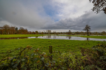 Fototapeta na wymiar Localised floodeding in a field at Currells avenue, Ballymena, County Antrim, Northern Ireland