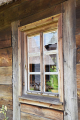 destroyed window in a rustic wooden cottage in the open-air museum