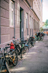Fototapeta na wymiar Row of parked colorful bikes on a street. Healthy lifestyle