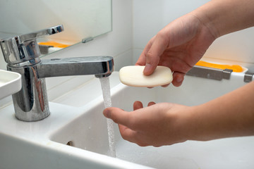 Washing hands with soap to protect against bacteria and viruses