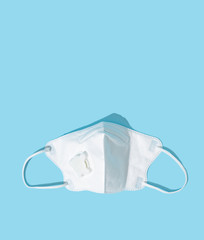 Respiratory or surgical face mask. Coronavirus or COVID-19 protection on blue background. Pandemic or epidemic concept.