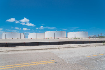 Fototapeta na wymiar Fuel storage tanks with stairs under blue sky at the roadside in Corpus Christi, Texas, America