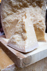 rediscovery of Red Cow Parmigiano Reggiano. Pieces of chopped parmesan at a farmers market with a price tag
