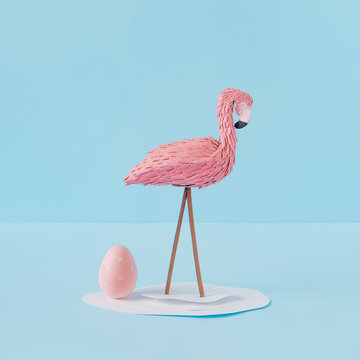 Creative composition with flamingo and pink Easter egg. Minimal spring or summer Holiday concept. Pastel fun background.