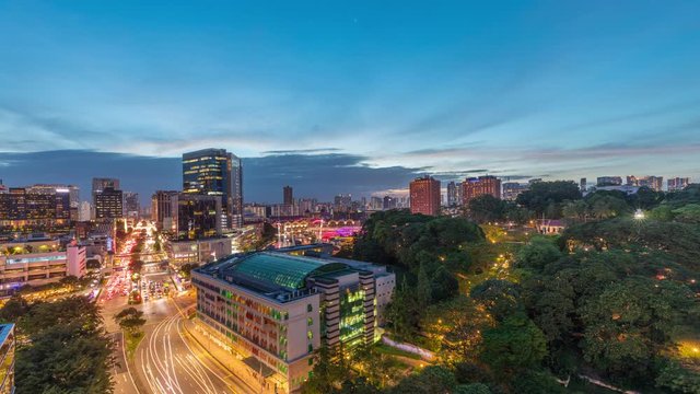 City skyline with Old Hill Street Police Station historic building in Singapore day to night transition aerial timelapse. Fort Canning Park and skyscrapers with New Bridge road on a background