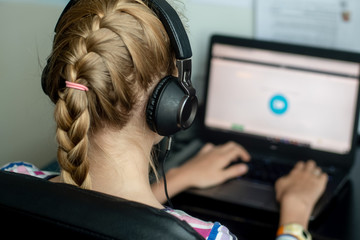 Coronavirus concept. Teenage girl sitting with her laptop - online learning from home