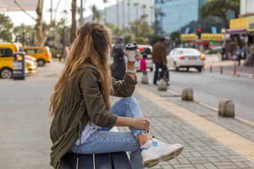 Portrait of a self-confident female in urban environment with ta