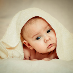 newborn baby lies on the bed