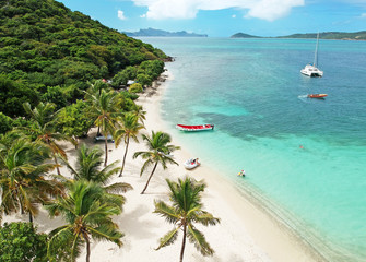 Aerial view of Petit Rameau tropical Caribbean Island beach, sailing catamarans and boats 