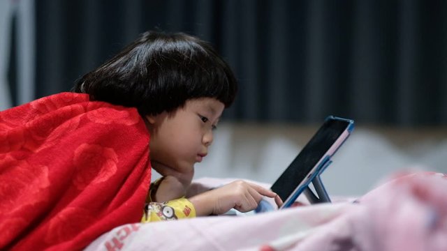 chinese child addicted phone, asian girl playing smartphone, kid use telephone, watching cartoon
