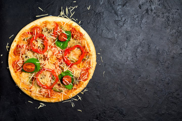 ingredients for vegetarian pizza on a dark background. pepper, cherry tomatoes, mushrooms, herbs, cheese. the view from the top , a place for a photo. vegan. round pizza for healthy eating